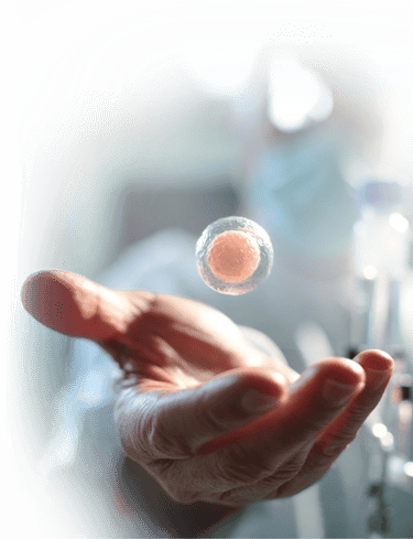 A human hand reaching toward a floating cell for stem cell therapy in mexico.