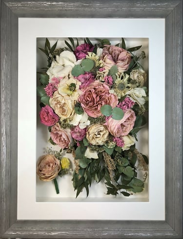 a trailing view preserved wedding bouquet of pink roses in a frame