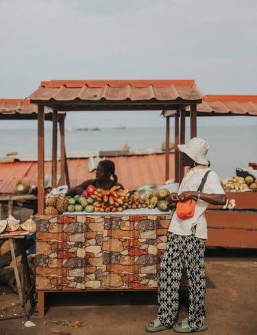 Kofi Dotse standing by a fruit shed in Sao Tome
