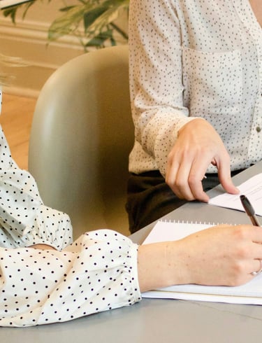 Two women sitting in a consulting and having in conversation in nutritional advice.