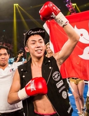 Photo of Hong Kong boxer Rex Tso in front of a Hong Kong flag