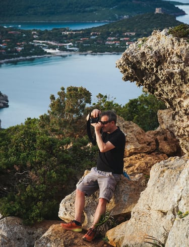 Franco Prisco photographing the landscape from Capo Caccia promontory, Sardinia.