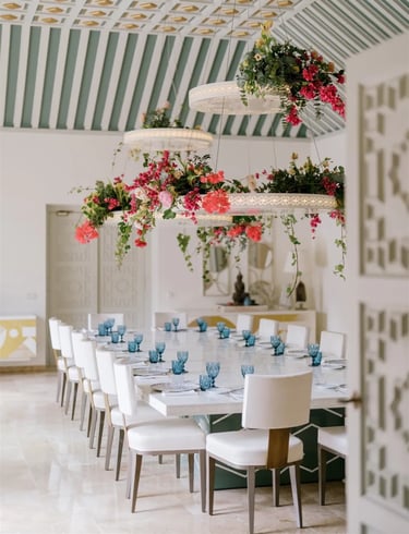 Dining room at Villa El Rincon with chandeliers and floral arrangements