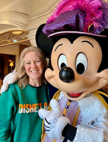 Leslie Hammer pictured with Mickey Mouse at Disneyland® Paris.