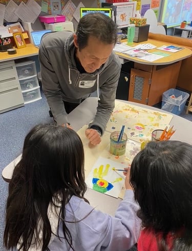 Arturo Ho works with students at Oakwood Elementary School