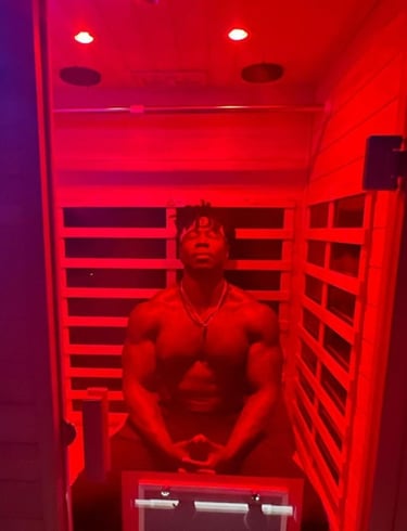 Muscular man relaxing in a Far Infrared Sauna.