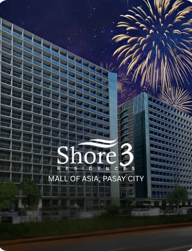 Shore 3 Residences luxury condominiums in Mall of Asia, Pasay City with fireworks at night.