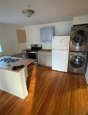 Washing machine and dryer being removed from basement during cleanout