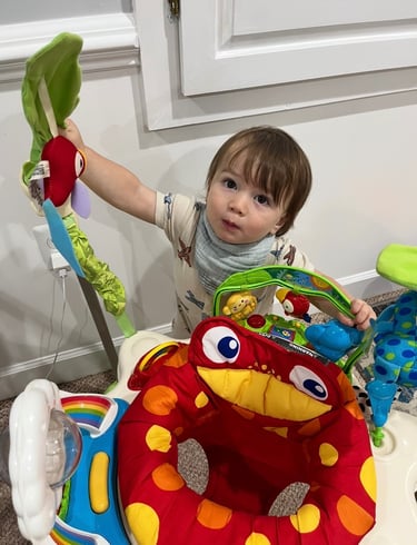 Young boy playing with a bouncy toy