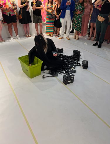 contemporary performance artist lvf.lvx pulling out vhs tapes in ritual performance tapes in drag