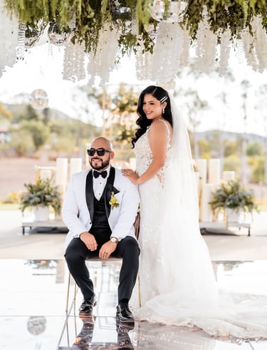 a bride and groom sitting on a chair in a wedding ceremony