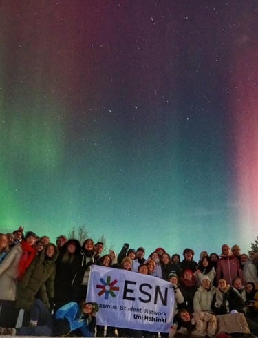 a group of people standing in front of a green and purple sky