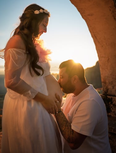 a pregnant woman is holding her belly while a man is holding her belly