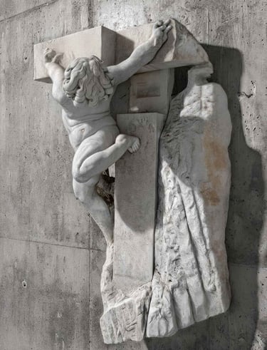 White marble sculpture depicting a child inserted into a stone cross, attached to a gray wall.