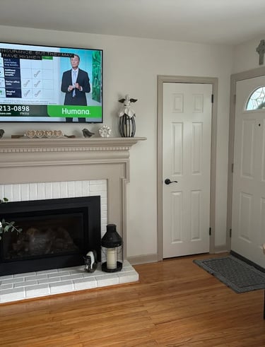 a living room with a television and a fireplace