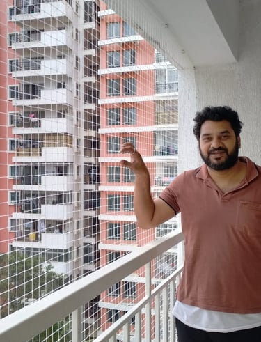 Happy family enjoying their balcony secured with a tight, professionally installed safety net.
