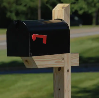 black steel mailbox on wooden post