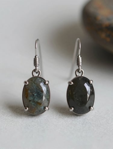 Finished handmade earrings displayed on a rustic wooden table.