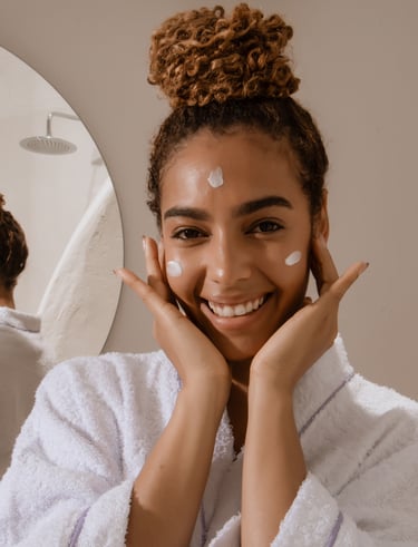 Woman in bathroom appyling azeliac acid serum to her face morning skincare routine