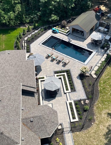 Leppek custom designed patio built in swimming pool. Landscaping, outdoor kitchen, paver patio.