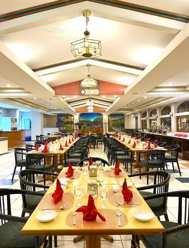 a restaurant with a long table and chairs