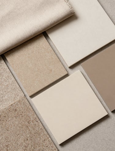 Close-up of hands arranging fabric swatches and color samples for an interior project.