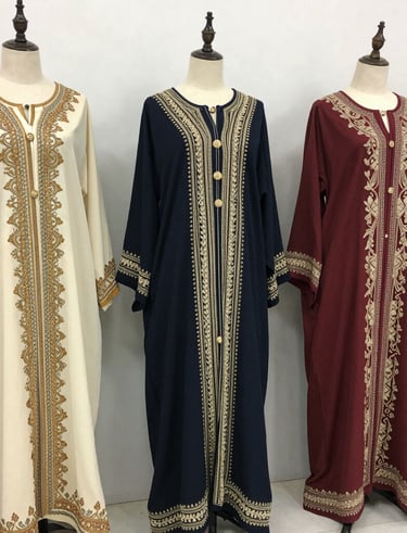 A beautifully arranged boutique interior showcasing kaftans and evening gowns in rich navy and gold tones.