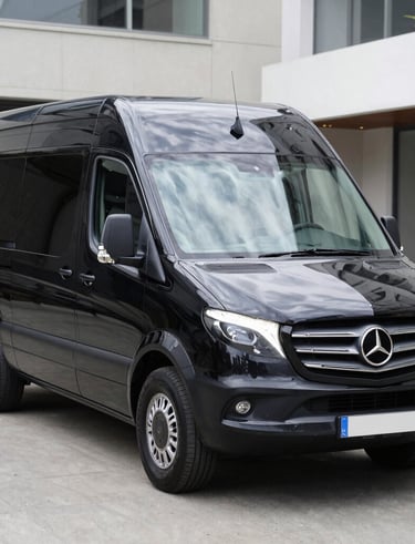 Professional driver assisting passengers with luggage at a mosque entrance.