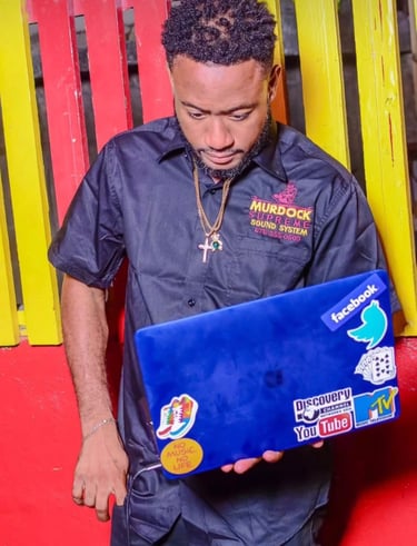 a man in a black shirt and a laptop