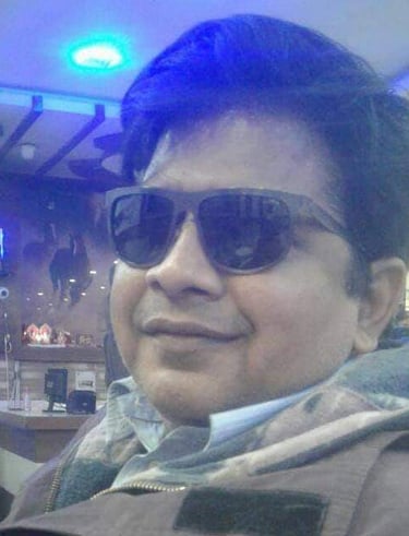 prashant srivastava in sunglasses and a scarf on a table