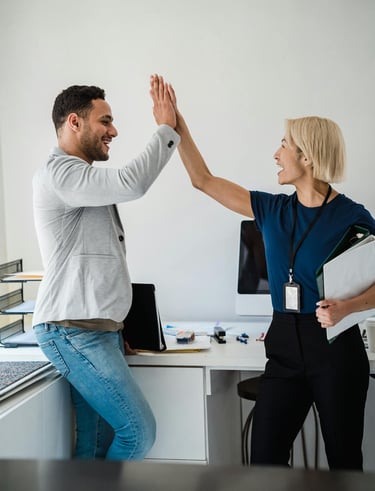 a man and woman giving each other high five fingers