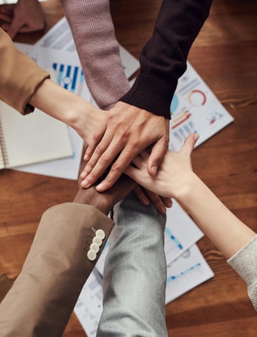 a group of people holding hands in a circle