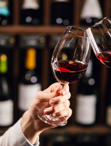 Two wine glasses clinking