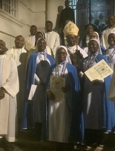 A group of Catholic clergy, nuns in blue habits, and a bishop standing on steps after a church ceremony.