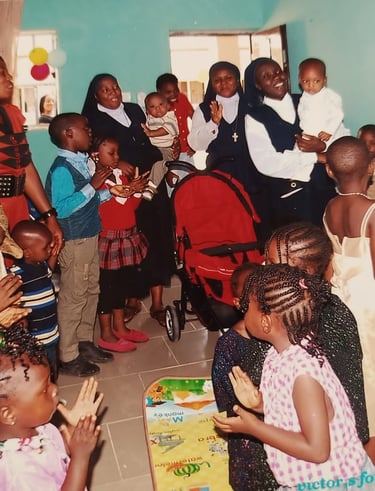 Catholic nuns and African children celebrating together in a joyful community gathering or school event.
