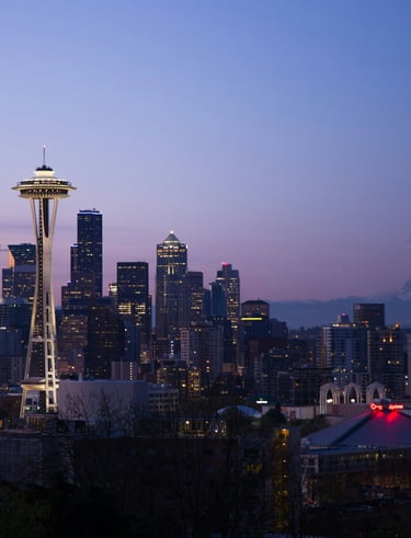 Seattle skyline view with professional transportation vehicle in the foreground.