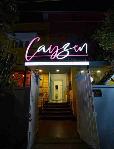 a neon sign that says,'Cayzen'