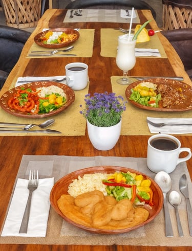 a table with plates of food and drinks