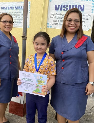  Elementary Student holding a certification with a teacher