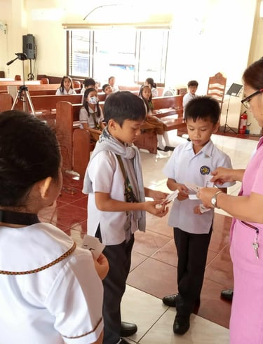 Teacher giving elementary students cards