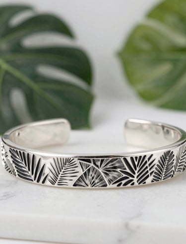 Elegant display of silver rings and necklaces on a sleek black and white background.
