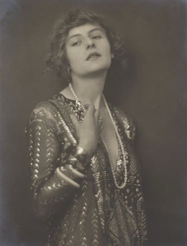 Black and white pho of Lady Carnarvon wearing Egyptian Assuit and pearls 1915