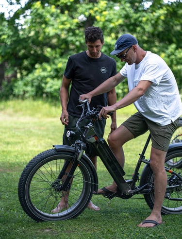 a man standing next to a man on a electric bike