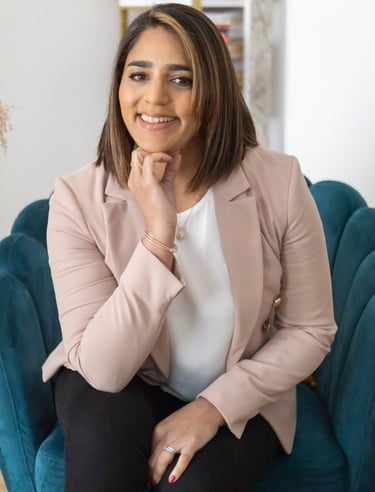 A photo of Anita. She is sitting on an arm chair.