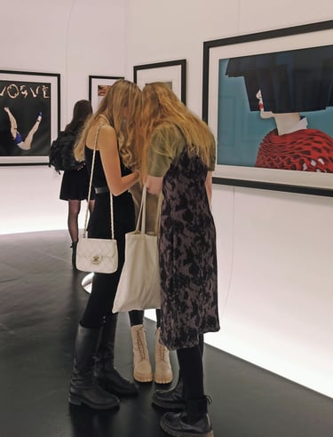 Visitors viewing refugee-led art exhibition in a contemporary gallery