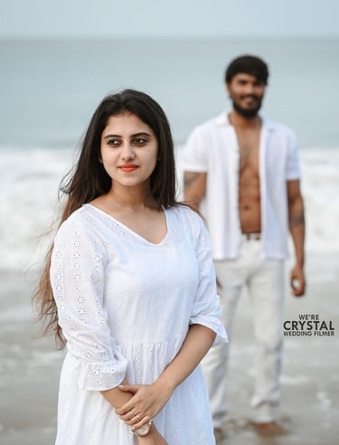 Save the date photoshoot in which bride and groom posing in white costumes on a beach in Kerala