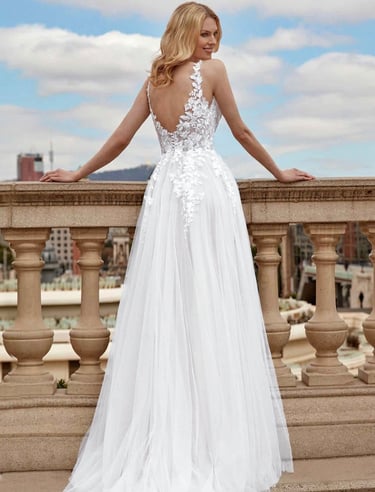 a woman in a white dress standing on a balcony