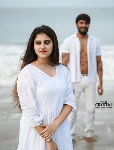 Save the date photoshoot in which bride and groom posing in white costumes on a beach in Kerala
