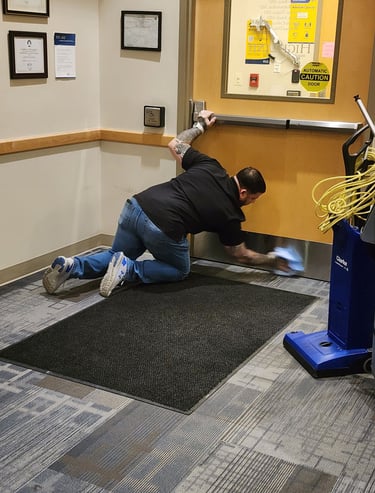 Staff member kneeling down cleaning