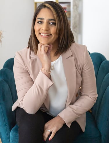 A photo of Anita. She is sitting on an arm chair.